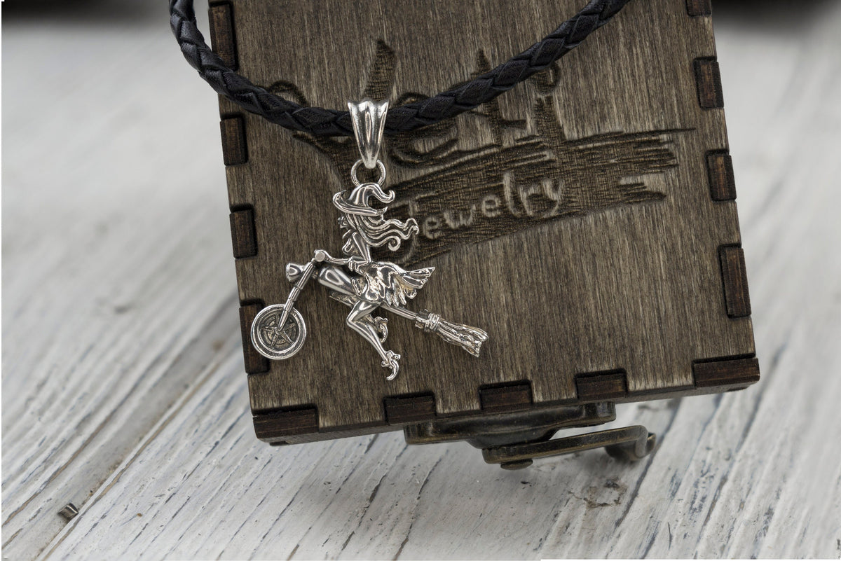 Allegra biker witch pendant on a cord over a wooden Yeti box