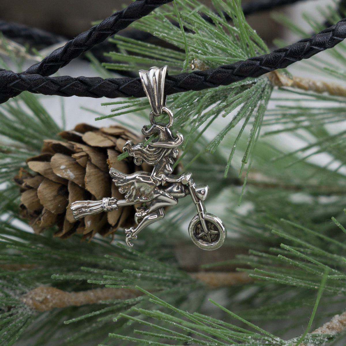 Allegra sterling silver witch pendant, side view of the motorcycle