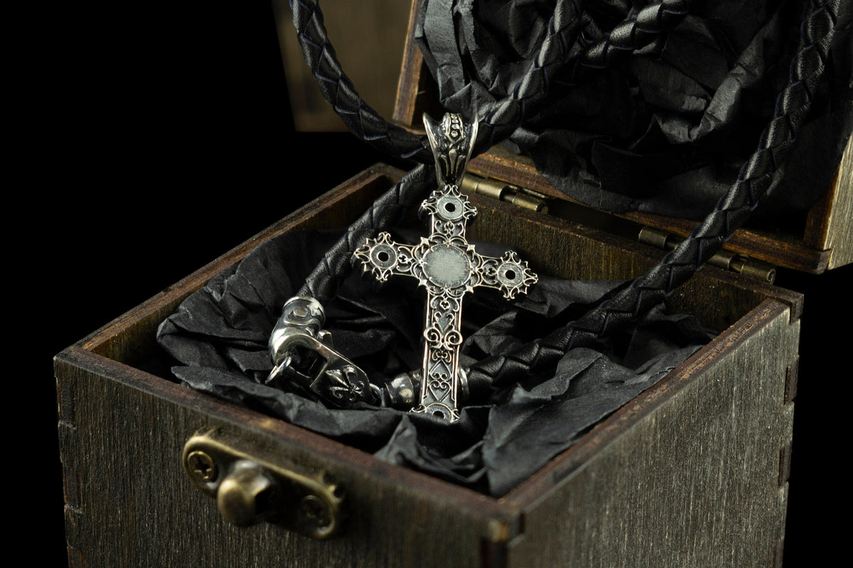 Aurora silver cross pendant with white center stone on a leather cord in a gift box
