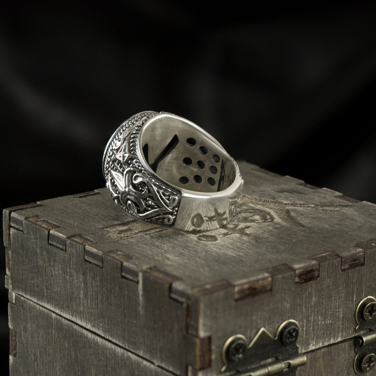 Blade Boss skull ring lying on its side, inside of the band