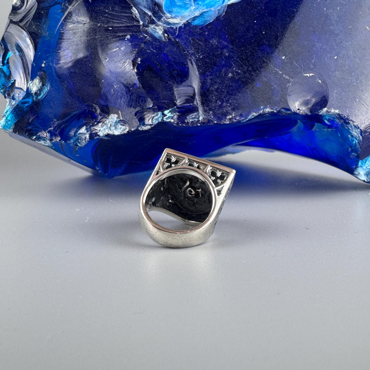 Shield skull ring lying on its side, inside of the band