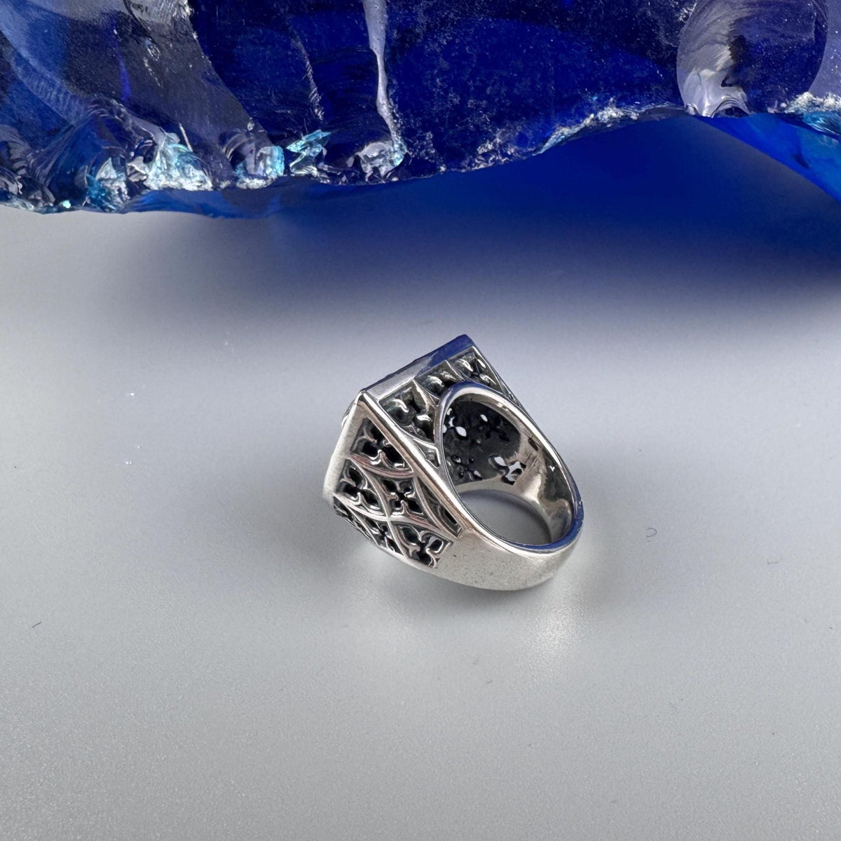 Shield skull ring side view with ornate openwork shoulder