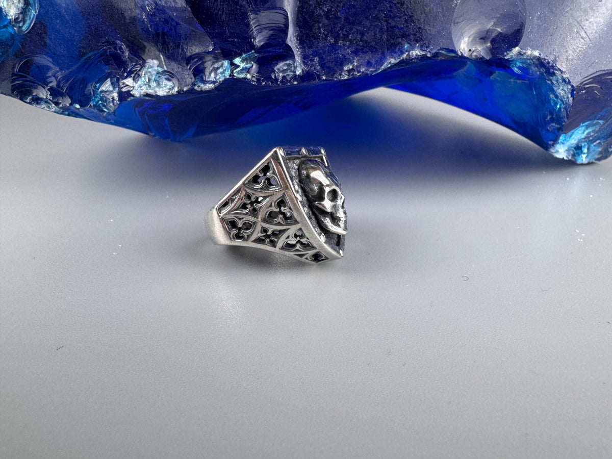 Shield skull ring from the side, ornate shoulder and band