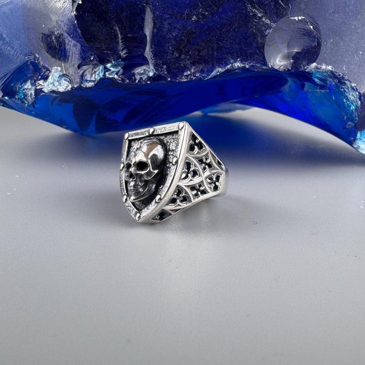 Shield skull ring three-quarter view with patterned shoulder