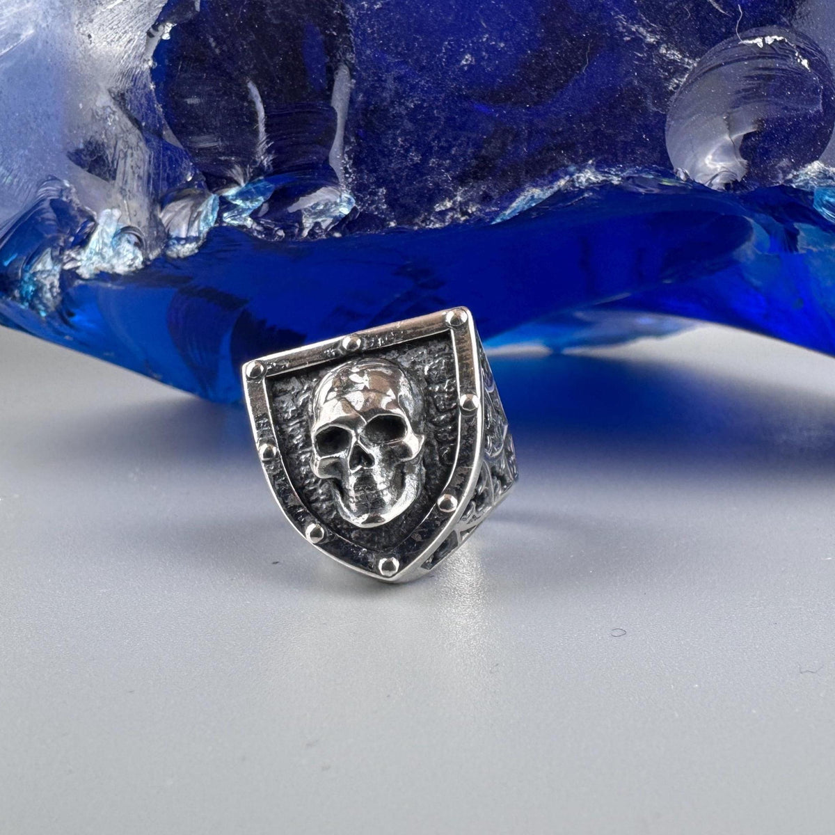 Close-up of the sculpted skull on the shield-shaped ring