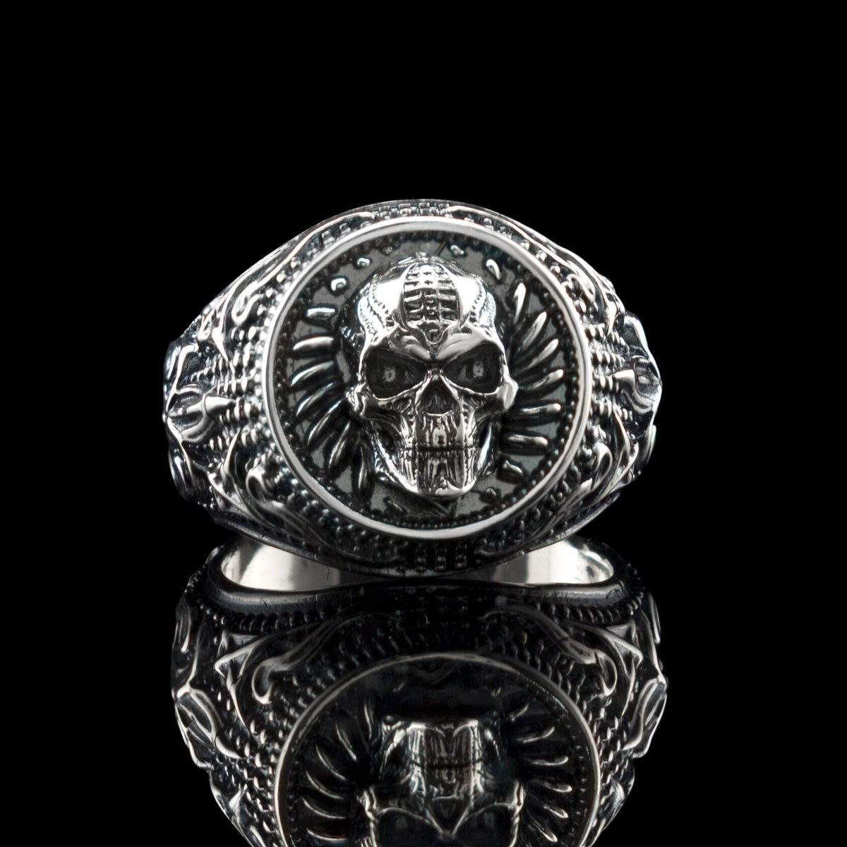 Blade Boss skull ring front view on black with reflection