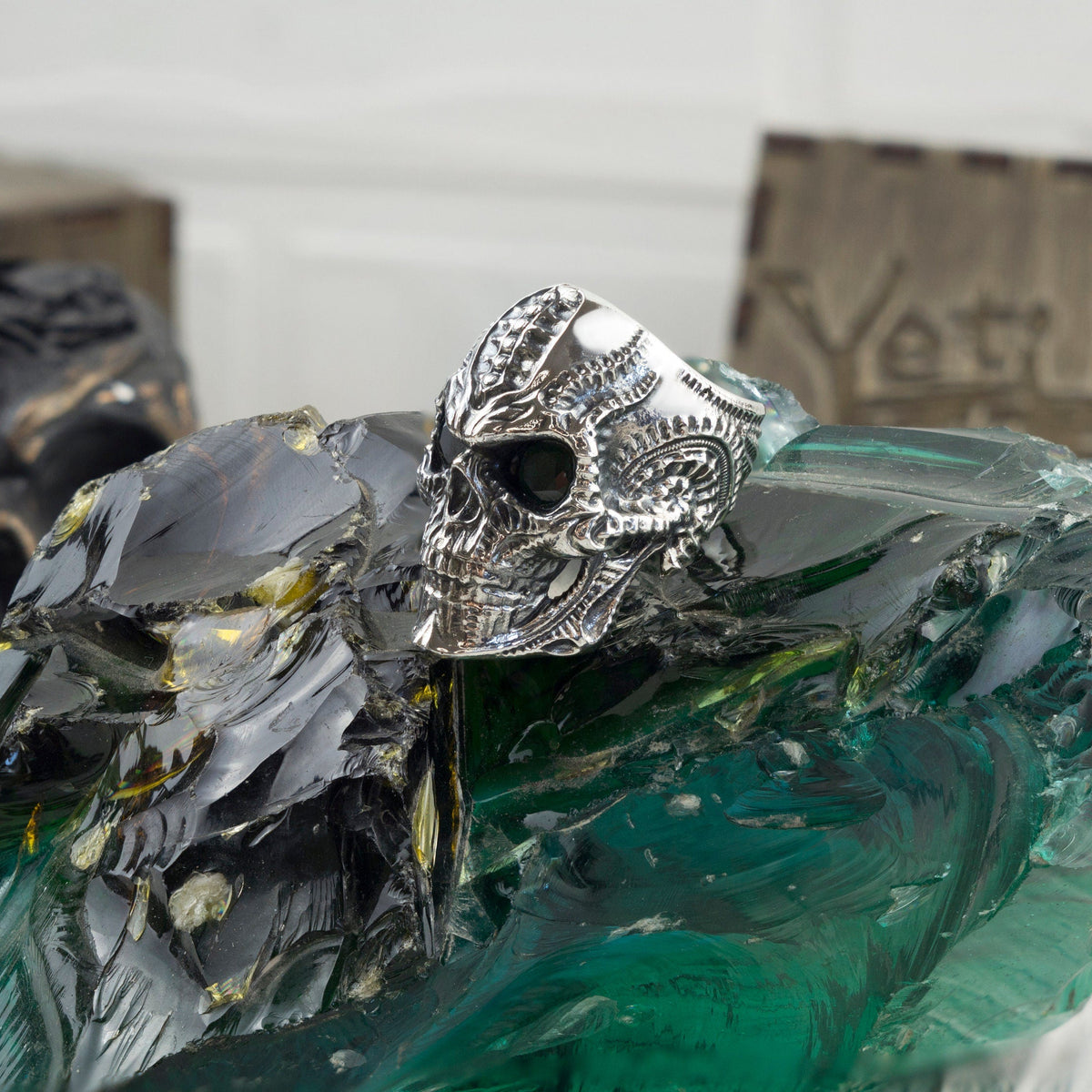 Blade skull ring with dark eyes, three-quarter view