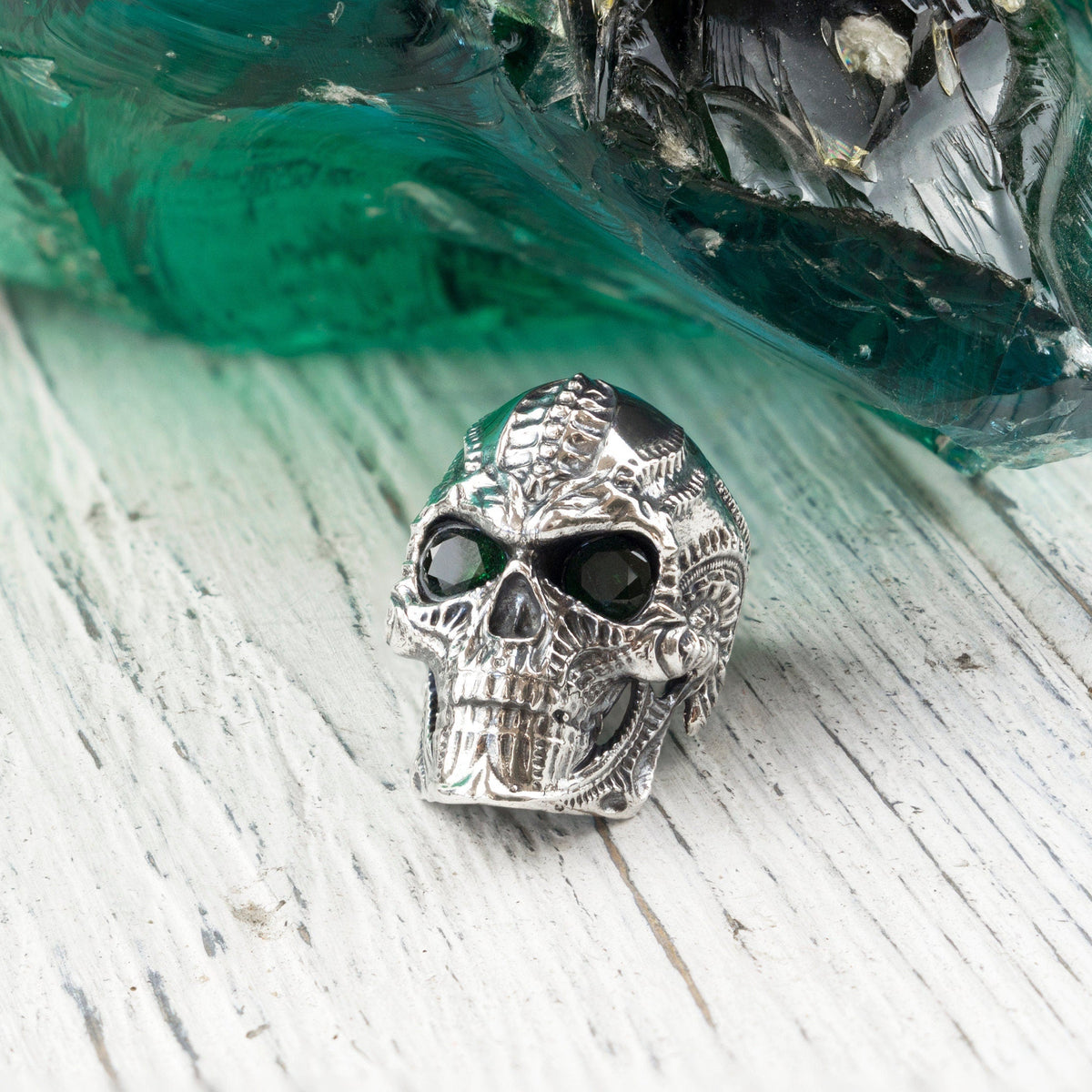 Blade biomechanical skull sterling silver ring on white wood