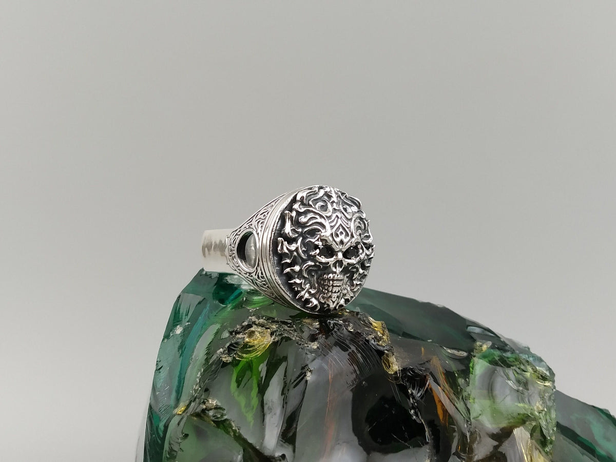 Blazing skull ring front view showing flame relief around the skull