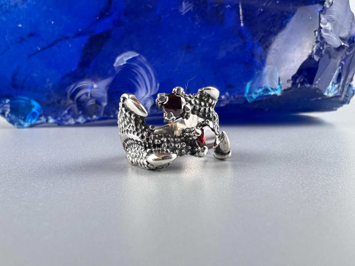 Crimson Claw dragon sterling silver ring with two red garnets, front view