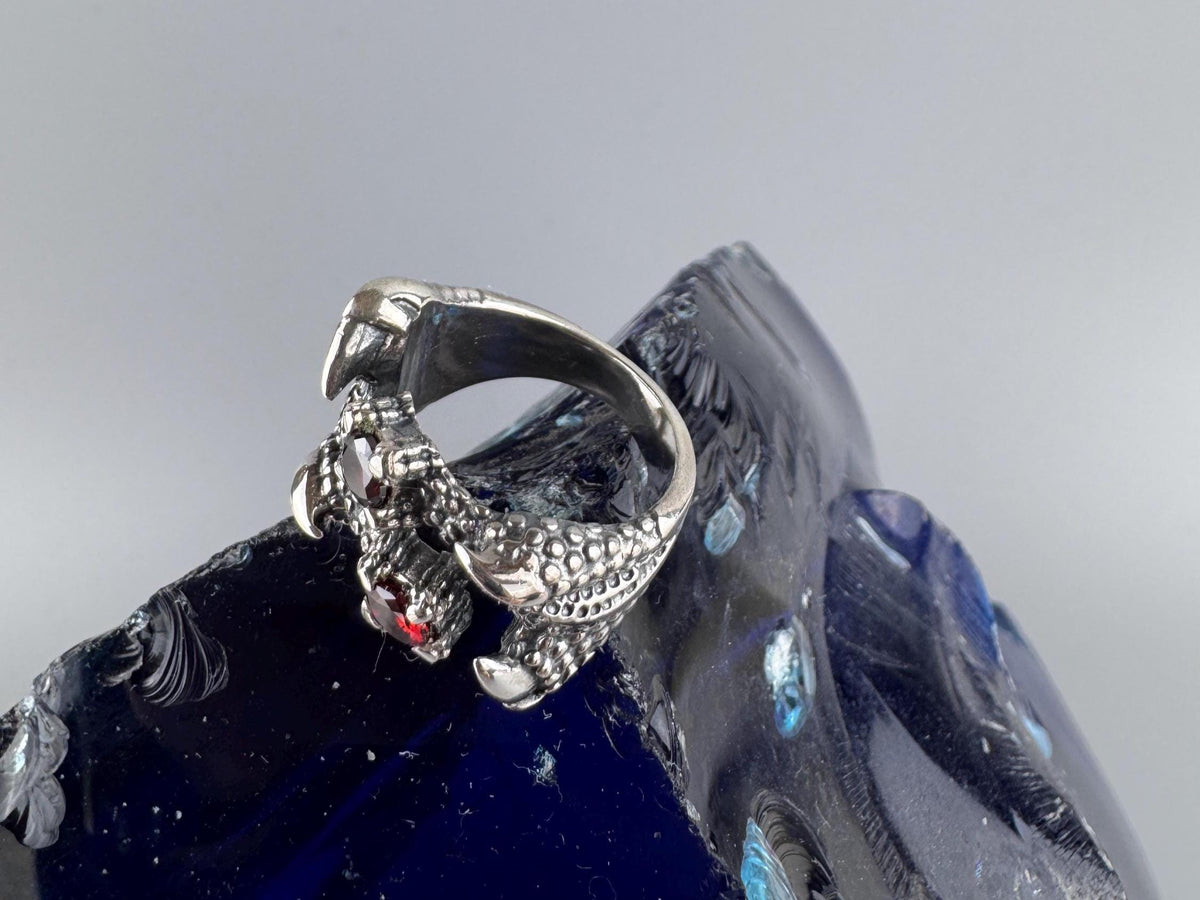 Close-up of the sculpted dragon claw and faceted red garnet
