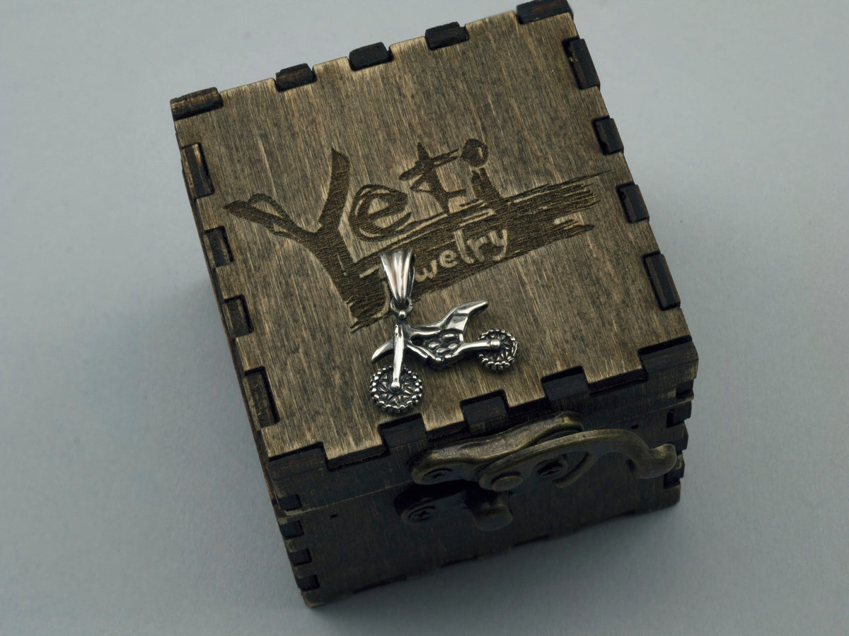 Enduro biker pendant displayed on an engraved wooden gift box