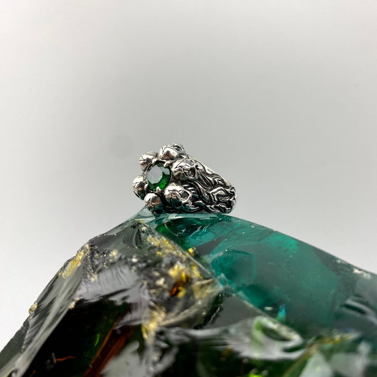 Furious Bonnie sterling silver skull ring with a faceted green center stone
