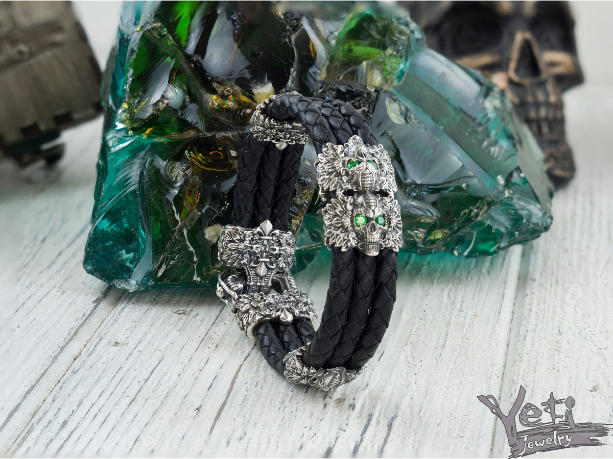 Garry skull leather bracelet front view, triple braided cords and silver skulls
