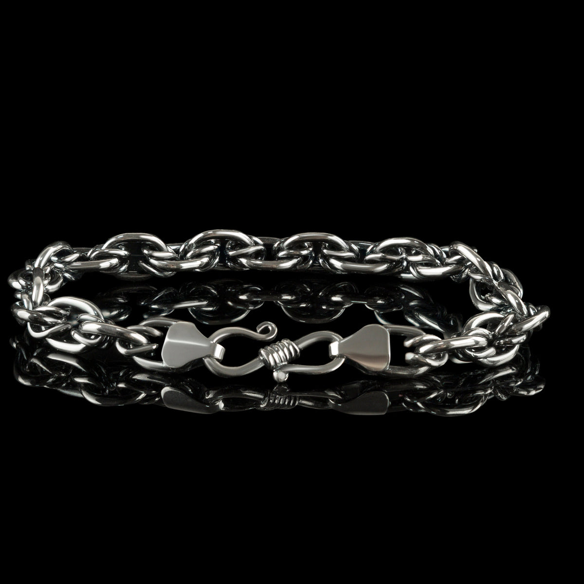 Graf chain bracelet with clasp in front, on black background