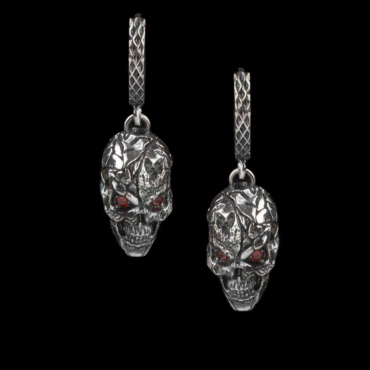 Headhunter skull earrings hanging side by side, front view