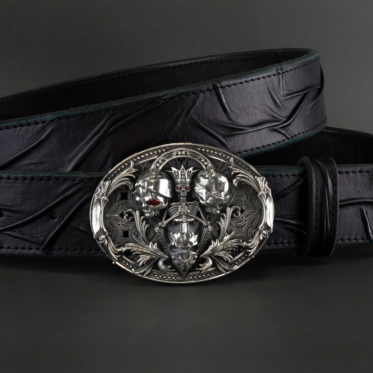 Hear Nothing See Nothing Say Nothing skull sterling silver belt buckle on a black leather belt