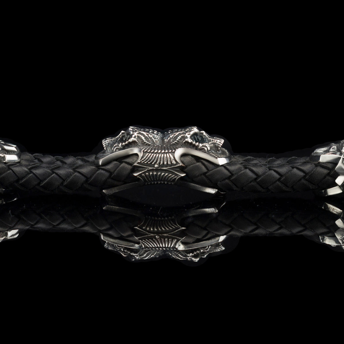 Heavy sterling silver skull bracelet on black braided leather, straight 2