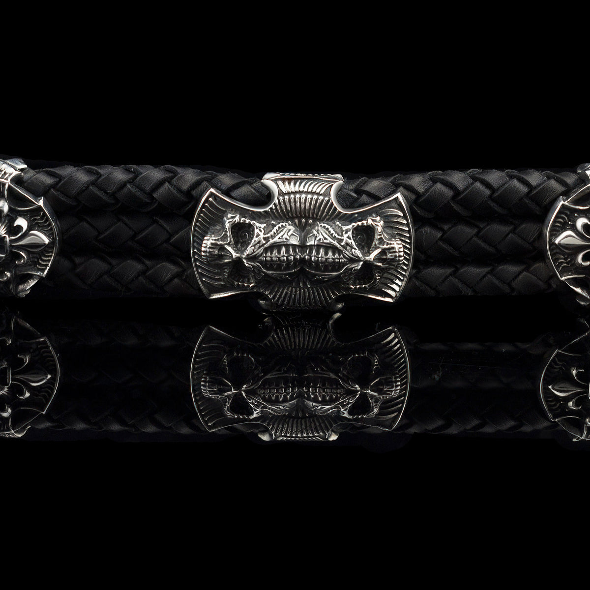 Heavy sterling silver skull bracelet on black braided leather, straight