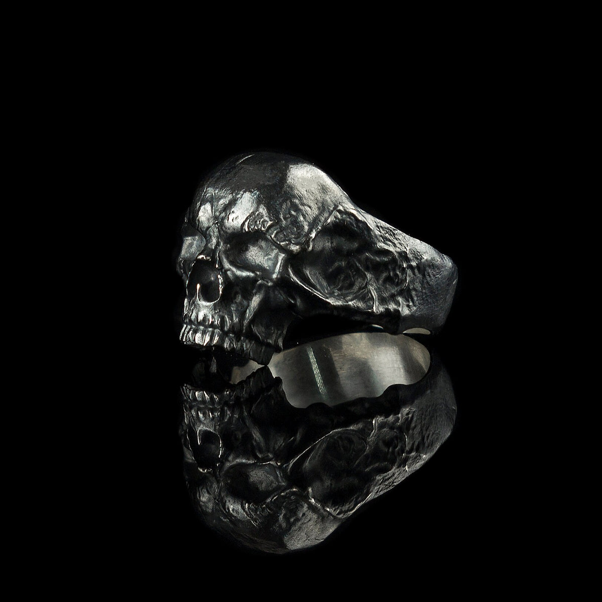 Hellbound skull biker ring, left side view showing cracked texture and smooth inner band