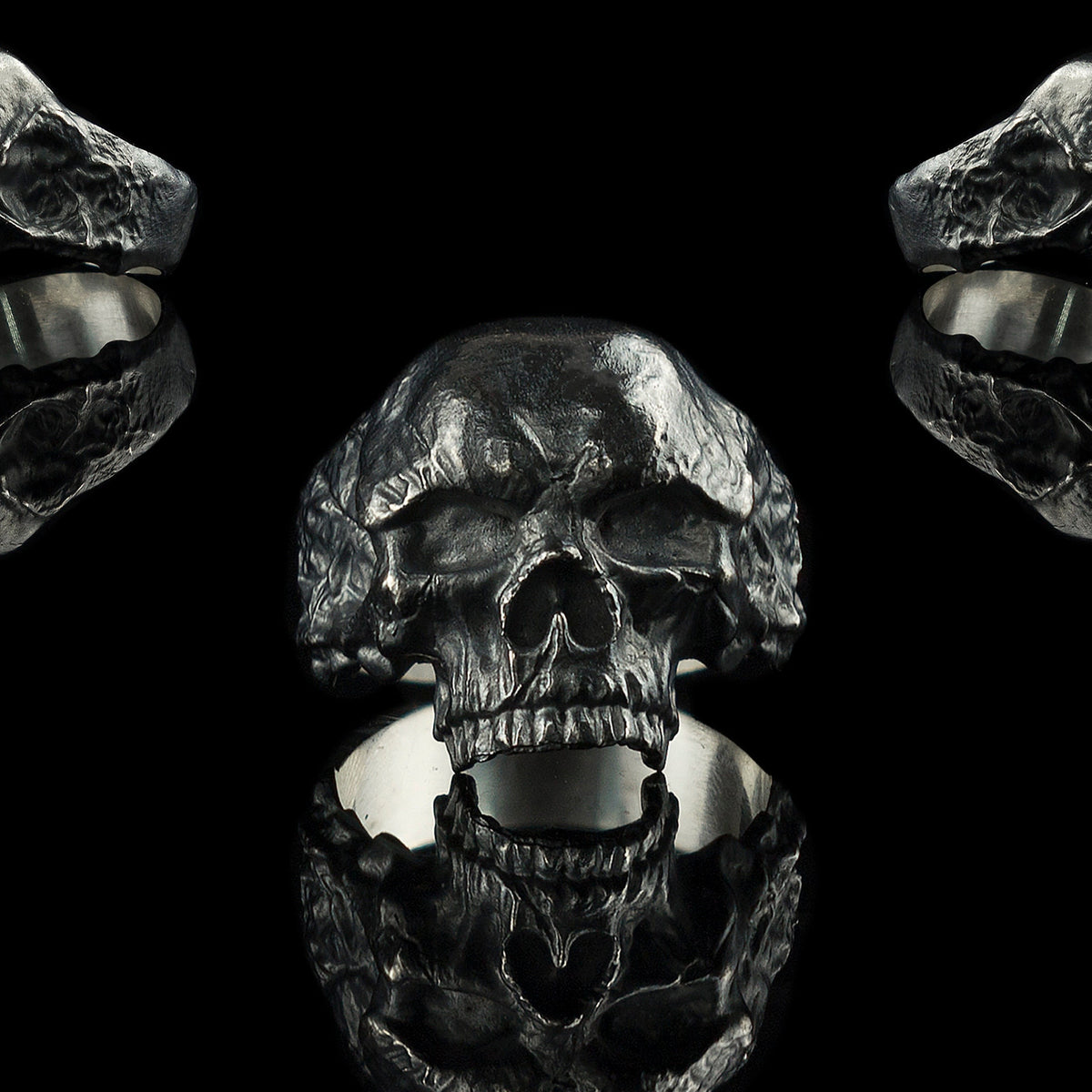 Hellbound sterling silver skull ring shown from front and both sides on black