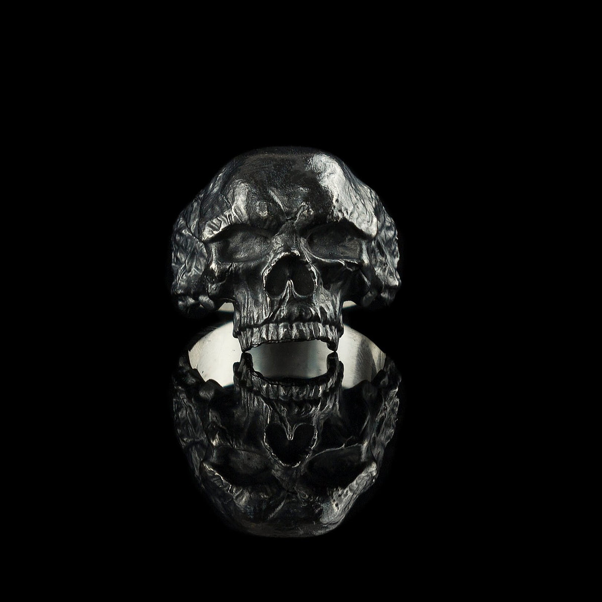 Hellbound sterling silver skull ring, front view of the open-jaw skull with darkened weathered texture