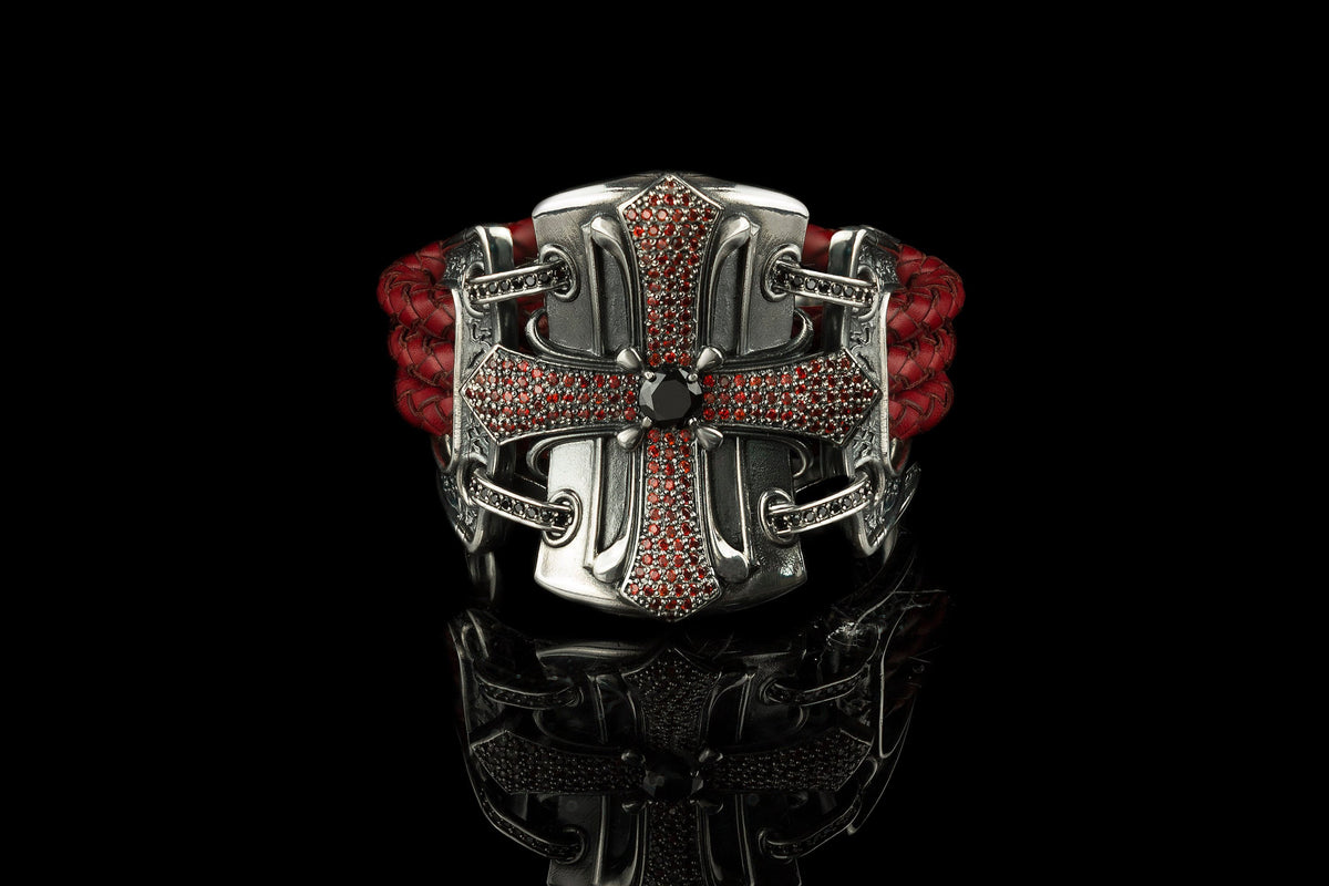 Queen of the Crusaders bracelet featuring an ornate 925 sterling silver cross, cubic zirconia details and braided red leather.