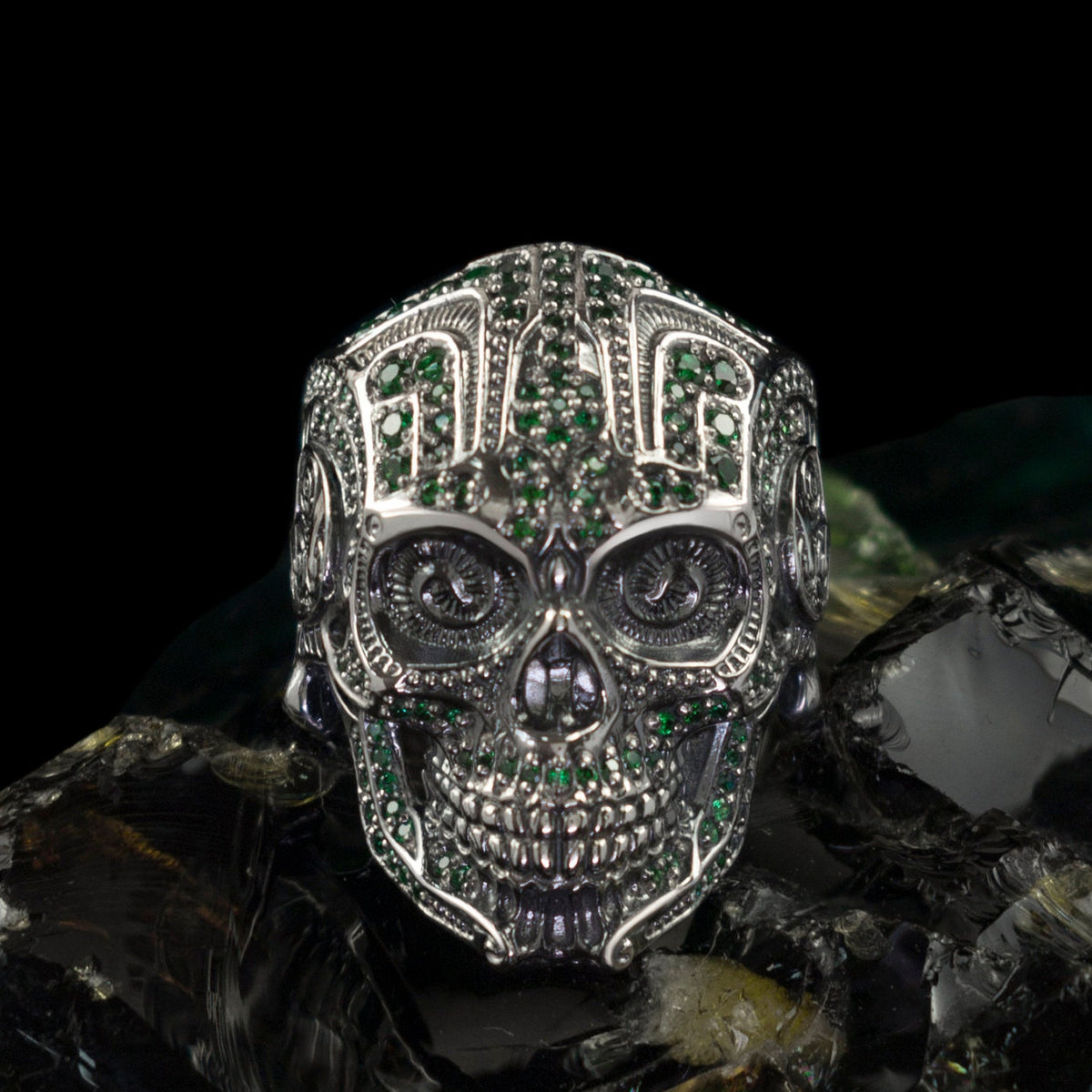 Mexican sugar skull ring in 925 sterling silver with green cubic zirconia stones and detailed calavera design by Yeti Jewelry
