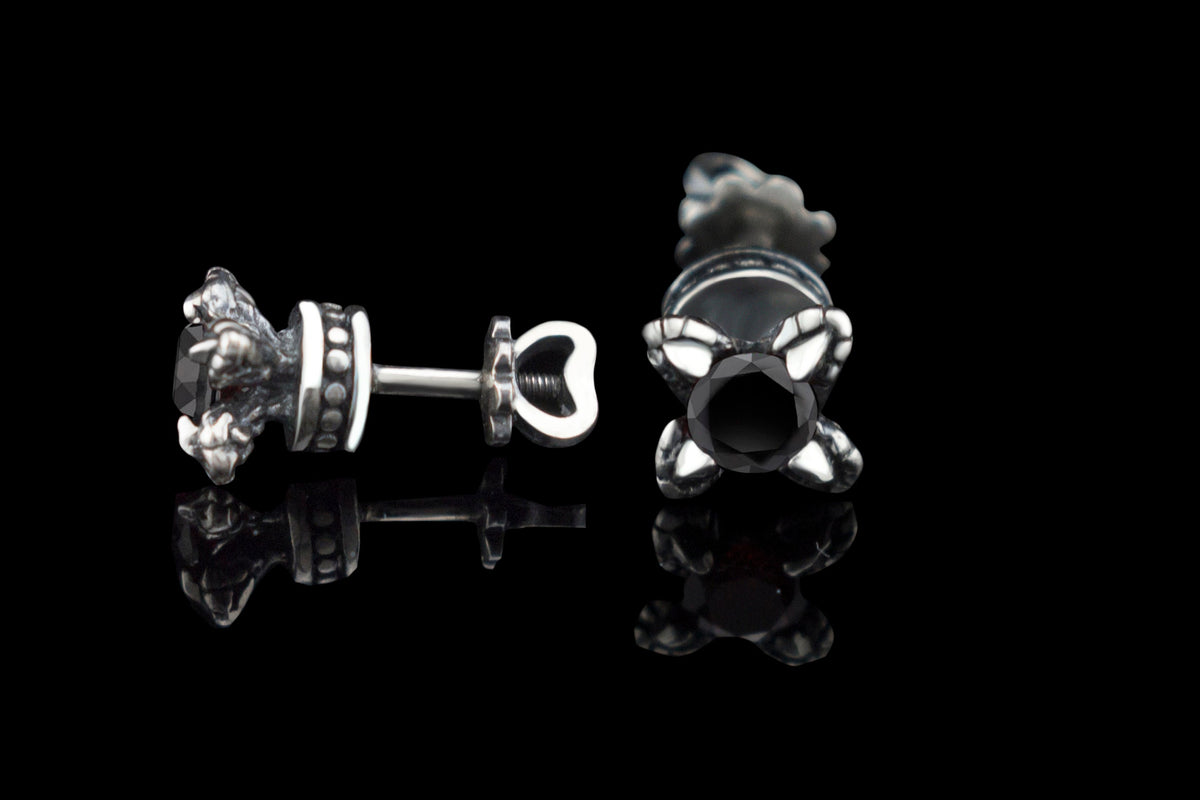Handcrafted 925 sterling silver "Giona" stud earrings featuring sapphire blue cubic zirconia stones in sculpted claw settings with screw-back closures