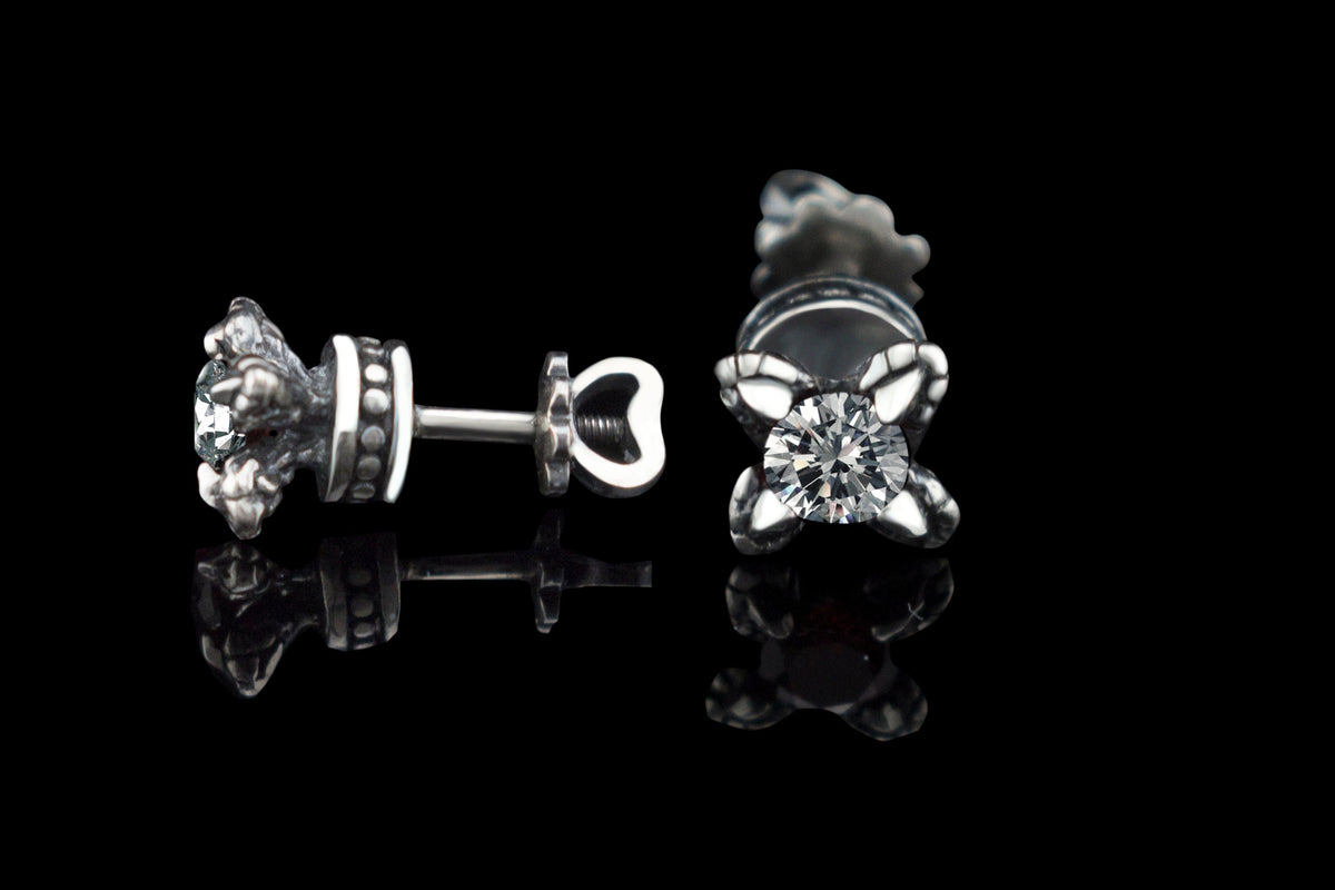 Handcrafted 925 sterling silver "Giona" stud earrings featuring sapphire blue cubic zirconia stones in sculpted claw settings with screw-back closures