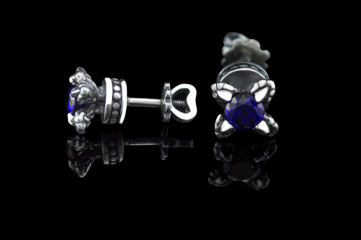 Handcrafted 925 sterling silver "Giona" stud earrings featuring sapphire blue cubic zirconia stones in sculpted claw settings with screw-back closures