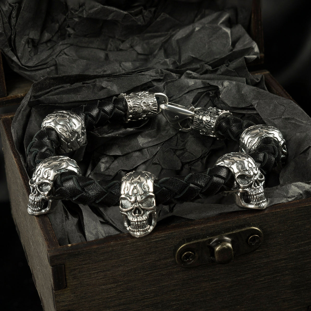 Wild 925 sterling silver skull bracelet with braided black leather band and multiple sculptural skulls