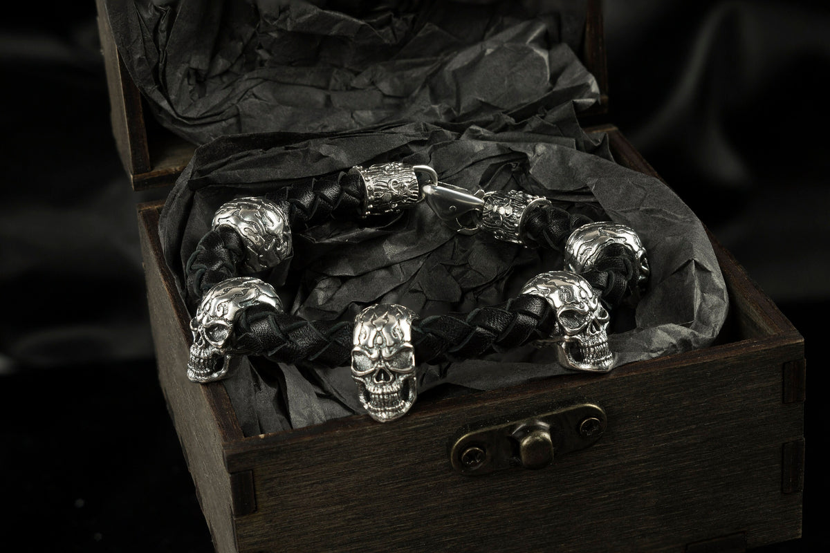 Wild 925 sterling silver skull bracelet with braided black leather band and multiple sculptural skulls