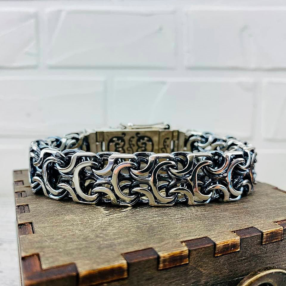 Heavy 925 sterling silver bracelet with intricate interlocking sculptural links, approximately 19 mm wide