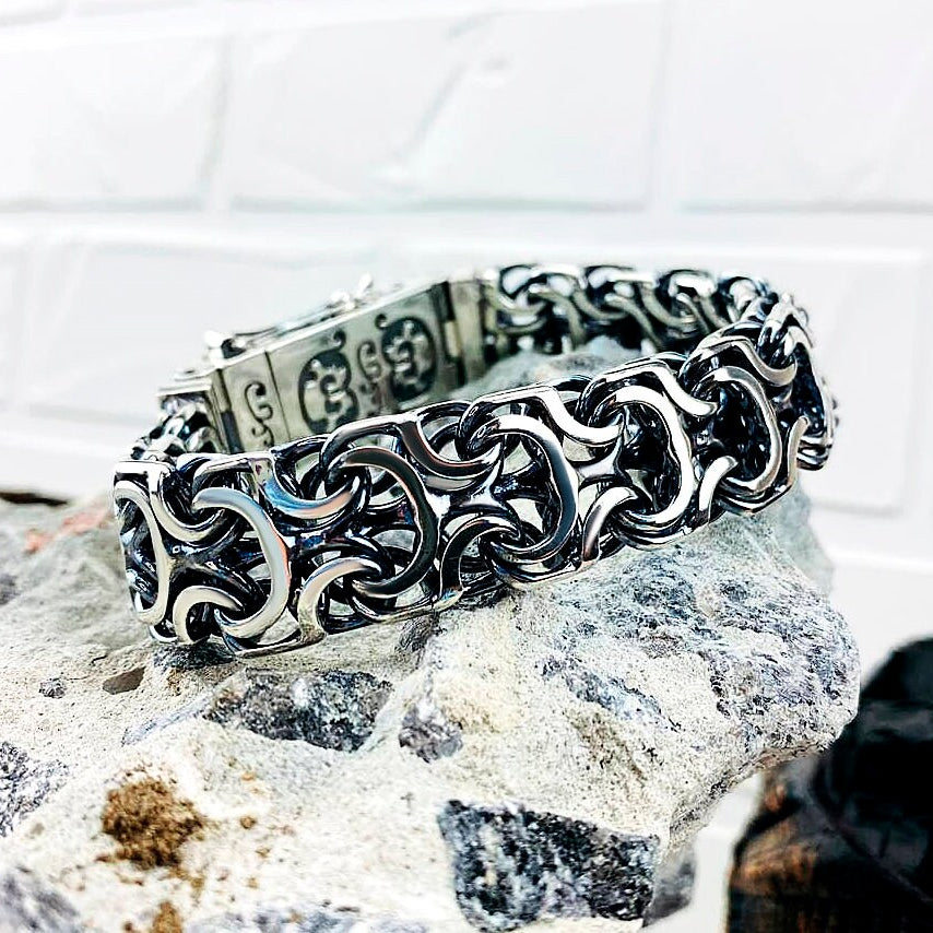 Heavy 925 sterling silver bracelet with intricate interlocking sculptural links, approximately 19 mm wide