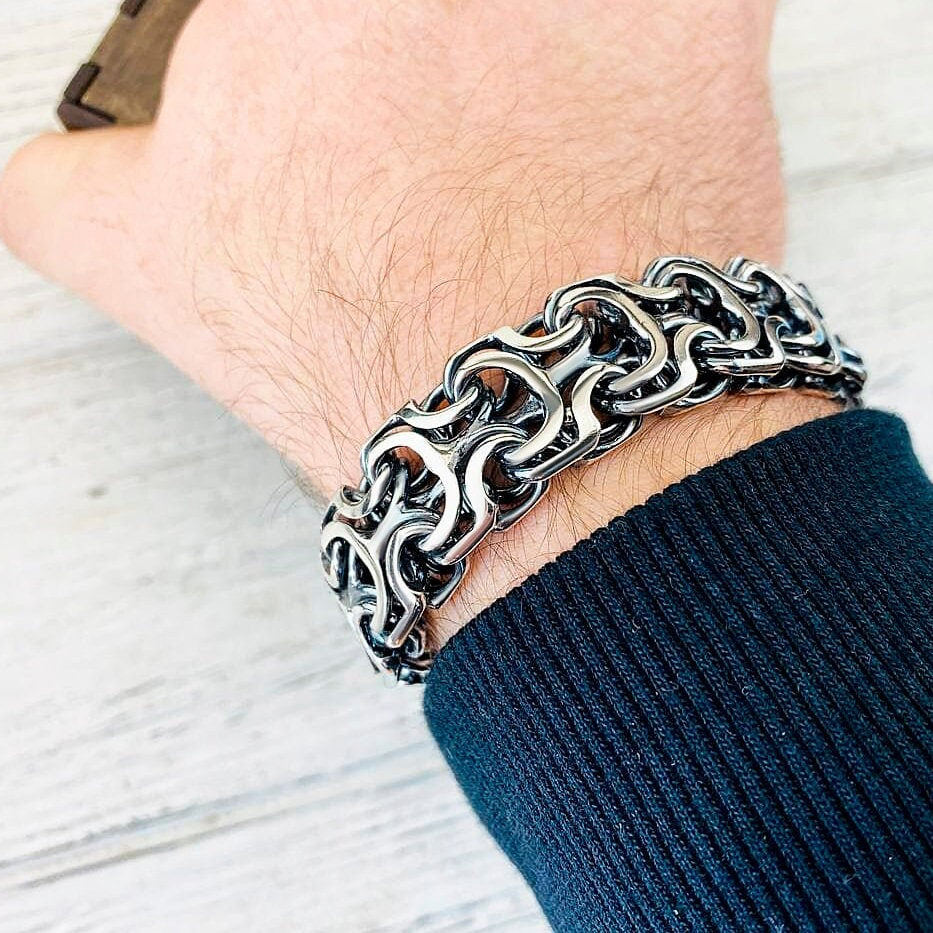 Heavy 925 sterling silver bracelet with intricate interlocking sculptural links, approximately 19 mm wide