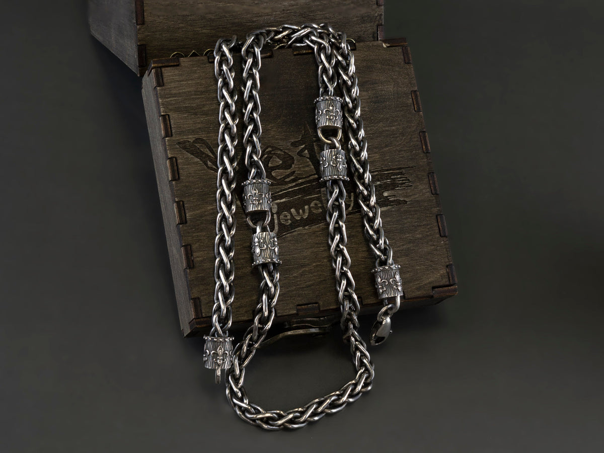 Heavy Fleur de Lis wheat chain necklace in 925 sterling silver with a 6.5 mm woven chain and ornate decorative end pieces, displayed on a wooden Yeti Jewelry box.