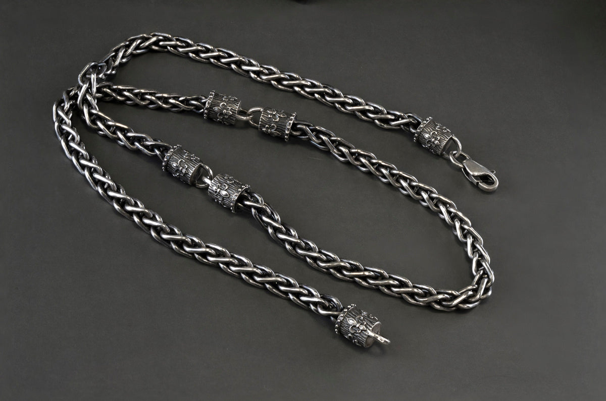 Heavy Fleur de Lis wheat chain necklace in 925 sterling silver with a 6.5 mm woven chain and ornate decorative end pieces, displayed on a wooden Yeti Jewelry box.