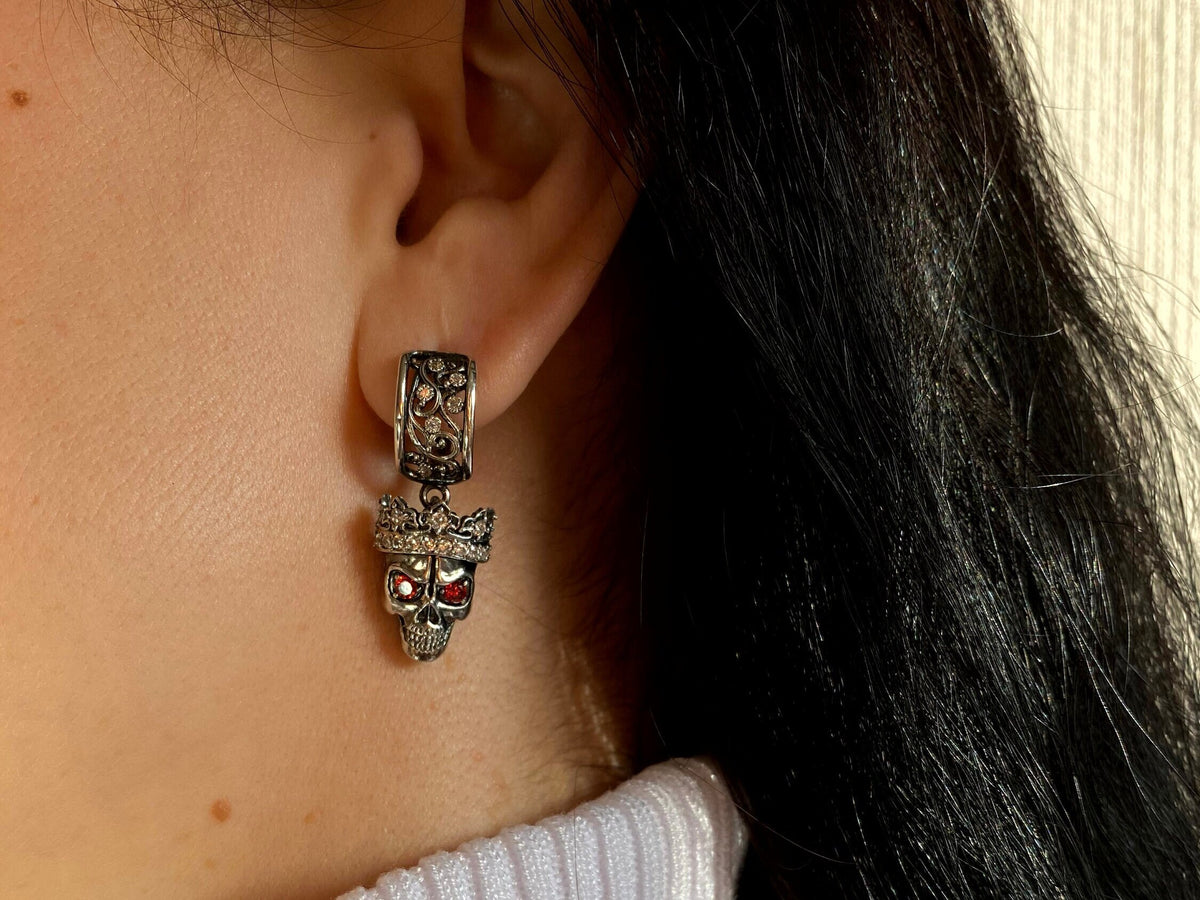 Santa Muerte-inspired 925 sterling silver skull earrings with crowned skulls and deep red cubic zirconia eyes