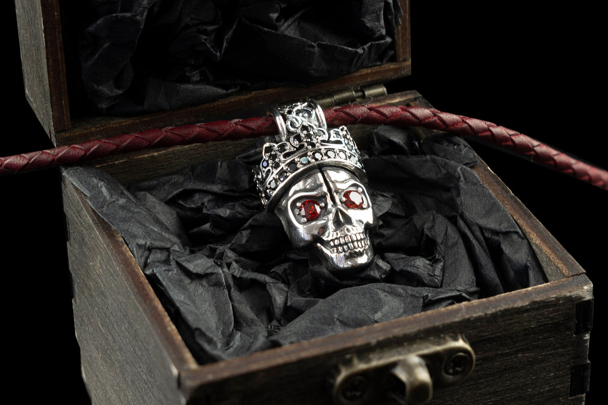 Santa Muerte skull pendant in 925 sterling silver with an ornate crown and red cubic zirconia eyes by Yeti Jewelry