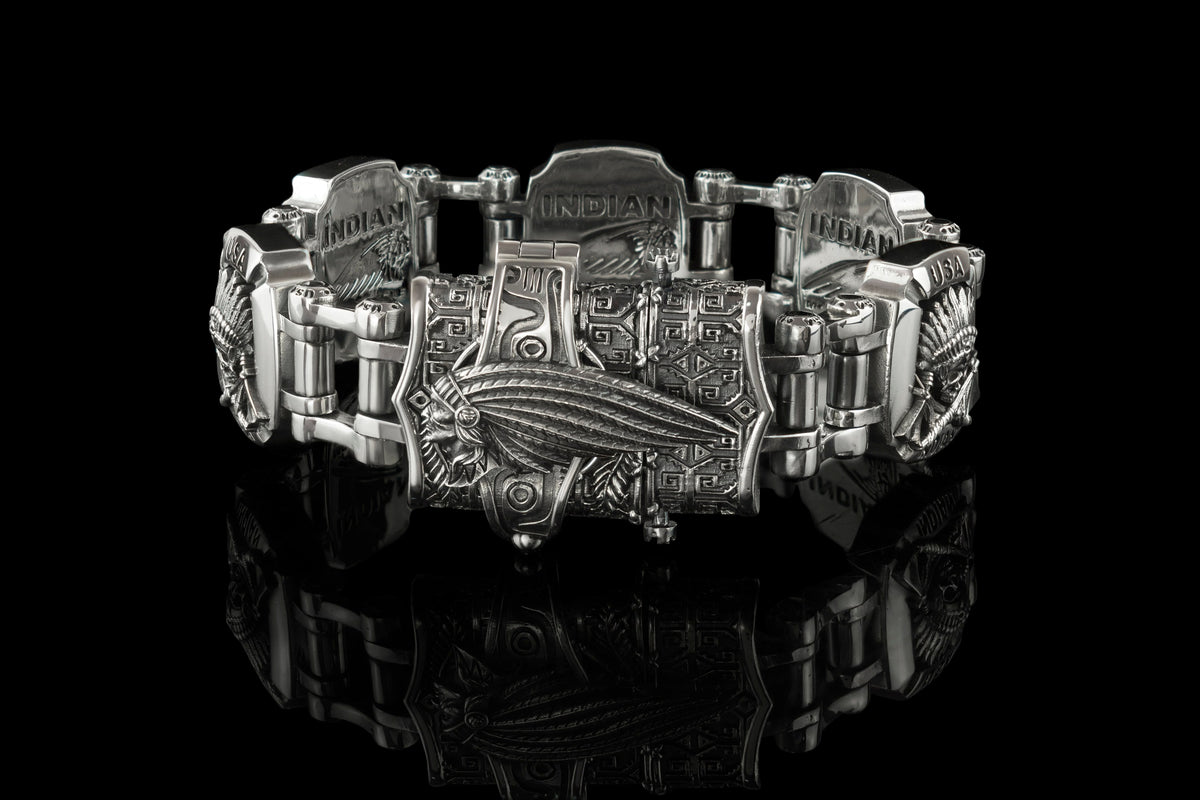 Heavy silver biker bracelet side view on black background
