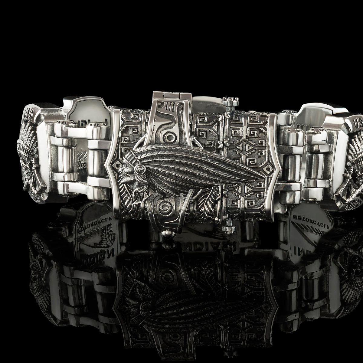 Close-up of the INDIAN lettering plate on the heavy silver bracelet
