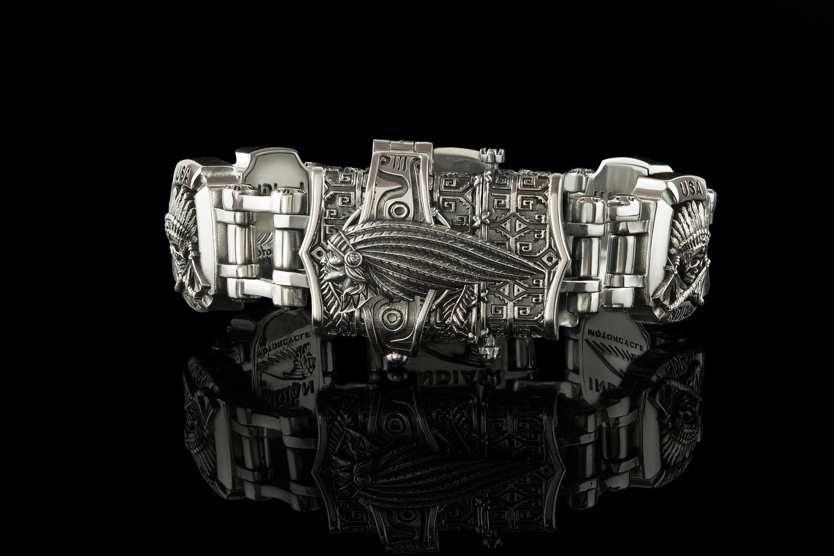 Close-up of the INDIAN lettering plate on the heavy silver bracelet