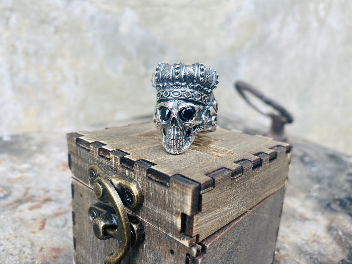King of Shadow ring on a wooden box, angled view of the skull