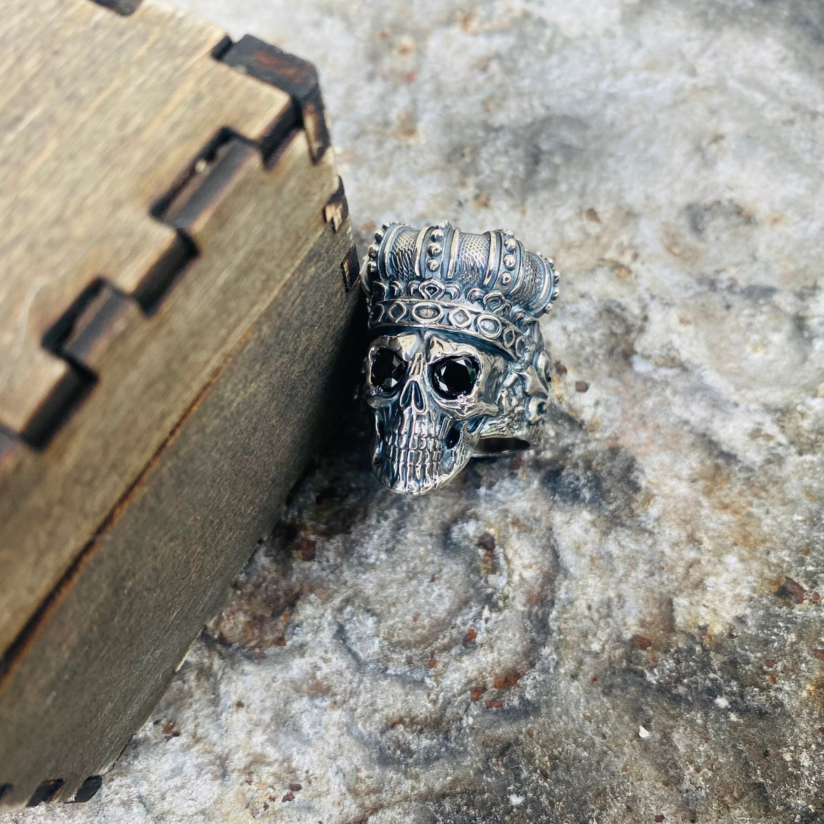 Close-up of the crowned skull face with dark stone eyes