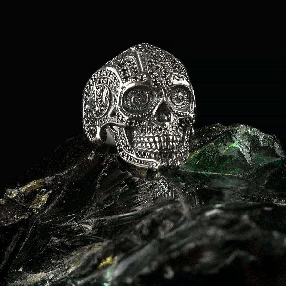 Mexican sugar skull sterling silver ring with black stones, angled view
