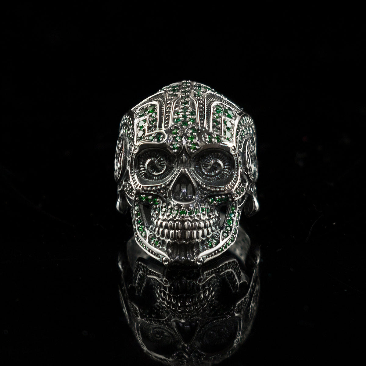 Sugar skull silver ring with green stones, front view