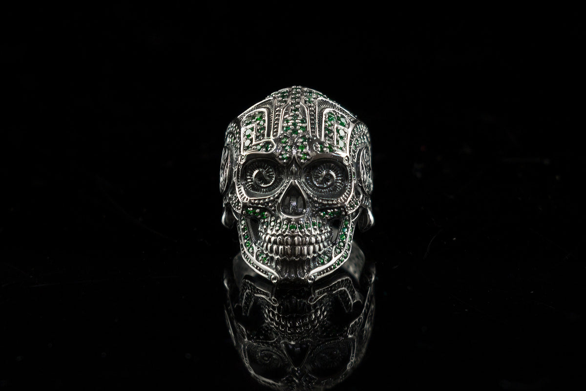 Sugar skull silver ring with green stones, front view