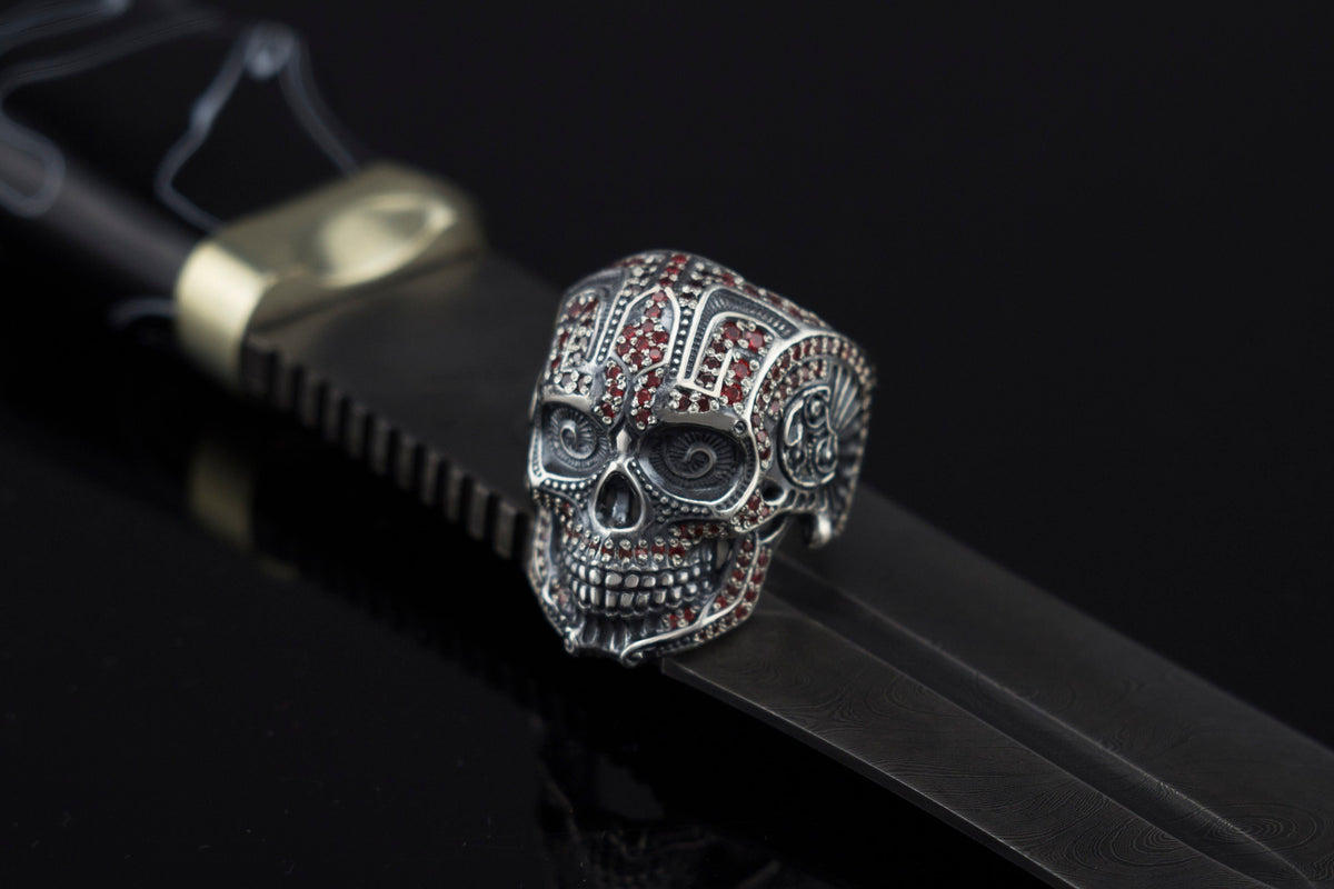 Sugar skull silver ring on a black leather strap, side view