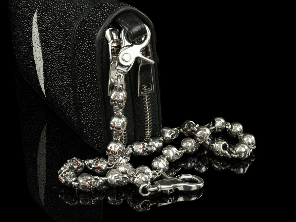 Silver skull biker wallet chain attached to a leather wallet, side view